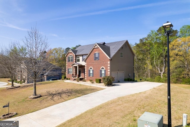 132 Windmeadow Way, Fayetteville, GA 30214 - view of front of house featuring driveway, a front yard, a garage, and brick siding