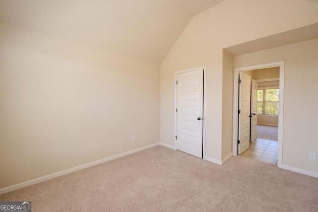 132 Windmeadow Way, Fayetteville, GA 30214 - unfurnished bedroom with vaulted ceiling, baseboards, and light colored carpet