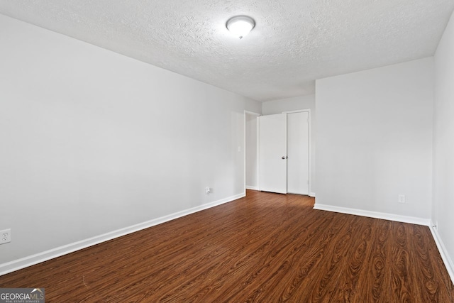 2199 Summertown Dr, Norcross, GA 30071 - spare room featuring a textured ceiling, dark wood finished floors, and baseboards
