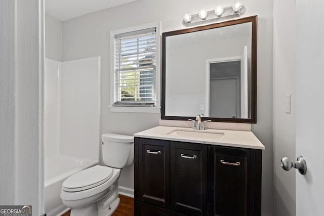 2199 Summertown Dr, Norcross, GA 30071 - full bathroom featuring vanity, toilet, wood finished floors, shower / bathtub combination, and baseboards