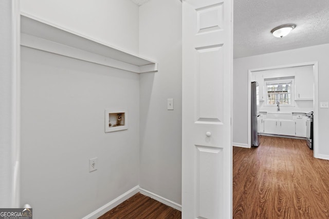 2199 Summertown Dr, Norcross, GA 30071 - laundry room with hookup for a washing machine, dark wood-style floors, baseboards, a sink, and a textured ceiling