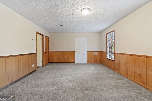 2199 Summertown Dr, Norcross, GA 30071 - carpeted spare room with wainscoting, wood walls, and a textured ceiling