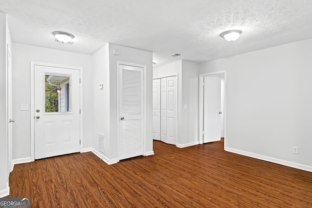 2199 Summertown Dr, Norcross, GA 30071 - entryway featuring dark wood finished floors, a textured ceiling, and baseboards