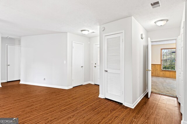 2199 Summertown Dr, Norcross, GA 30071 - spare room with wood finished floors, wainscoting, a textured ceiling, and baseboards