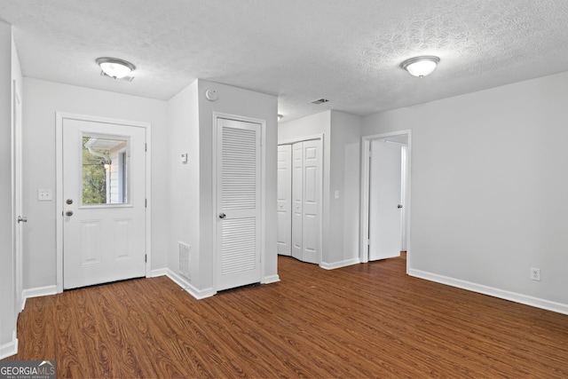 2199 Summertown Dr, Norcross, GA 30071 - foyer entrance featuring wood finished floors, a textured ceiling, and baseboards
