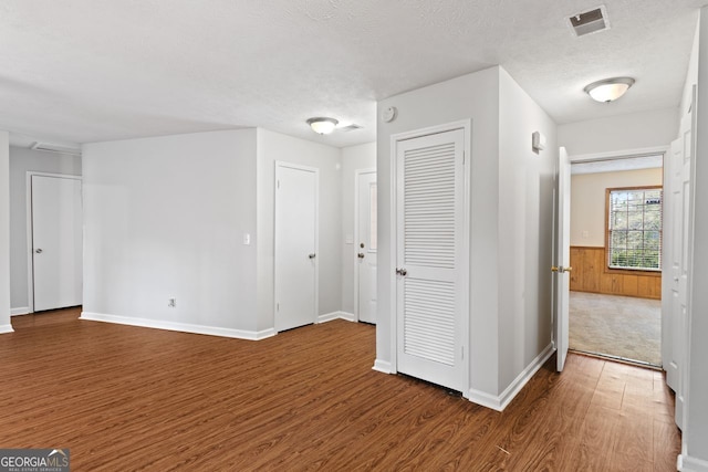 2199 Summertown Dr, Norcross, GA 30071 - corridor featuring wood finished floors, a wainscoted wall, a textured ceiling, and baseboards