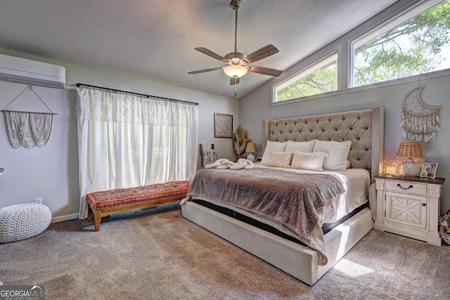 bedroom with a wall mounted air conditioner, carpet floors, vaulted ceiling, and ceiling fan