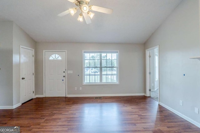 foyer entrance with baseboards, lofted ceiling, ceiling fan, and wood finished floors