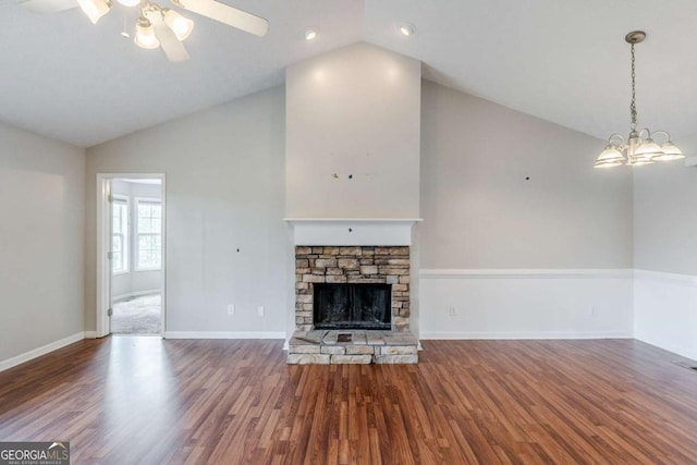 unfurnished living room featuring lofted ceiling, a fireplace, and wood finished floors
