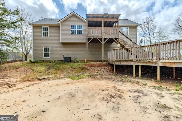 back of house featuring central air condition unit, stairway, and a deck