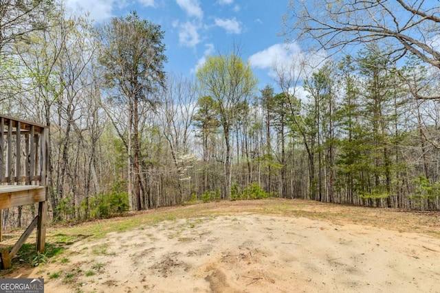 view of yard featuring a forest view