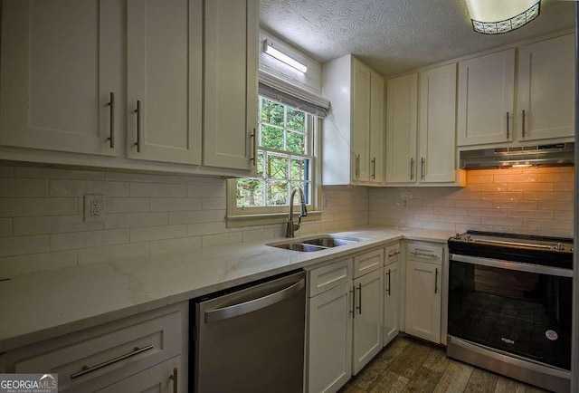 2048 Kelvin Dr, Lawrenceville, GA 30043 - kitchen featuring appliances with stainless steel finishes, under cabinet range hood, white cabinetry, backsplash, and a textured ceiling
