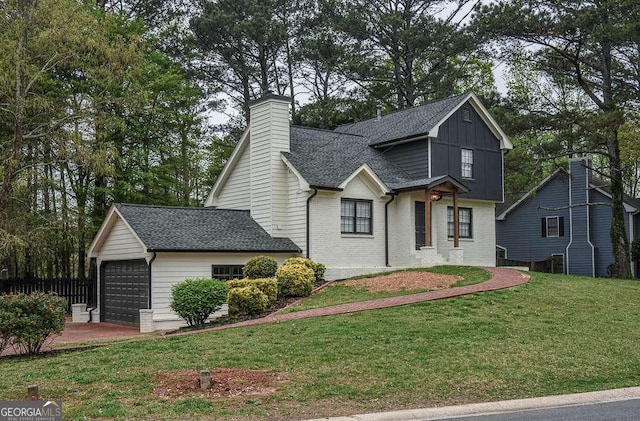 2048 Kelvin Dr, Lawrenceville, GA 30043 - traditional home with a front yard, a shingled roof, a chimney, brick siding, and board and batten siding