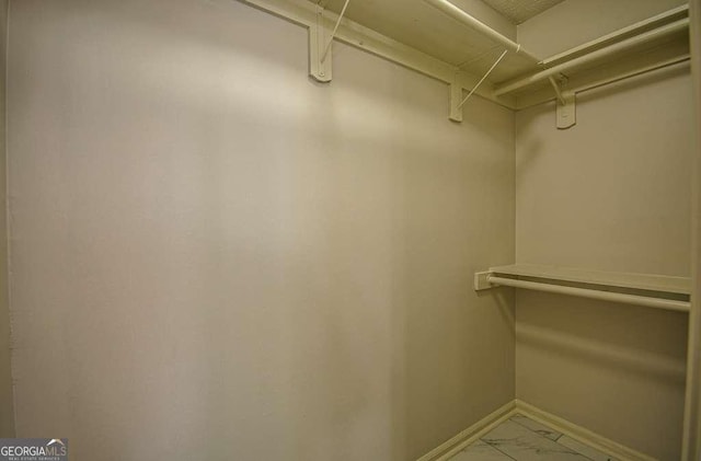 2048 Kelvin Dr, Lawrenceville, GA 30043 - walk in closet with light marble finish floors