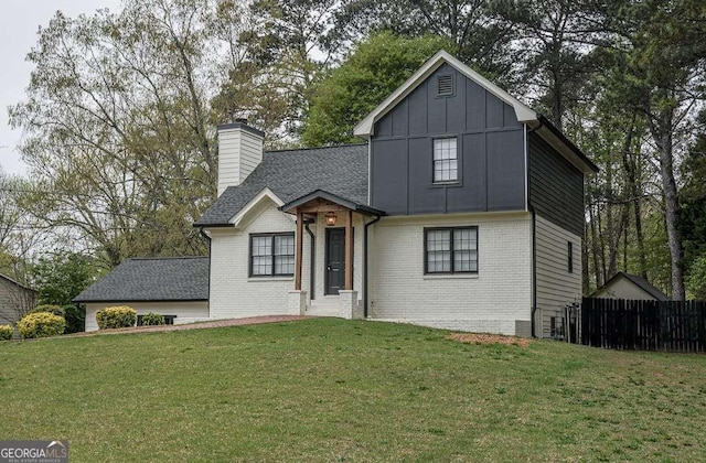 2048 Kelvin Dr, Lawrenceville, GA 30043 - view of front of house with brick siding, a chimney, board and batten siding, and roof with shingles
