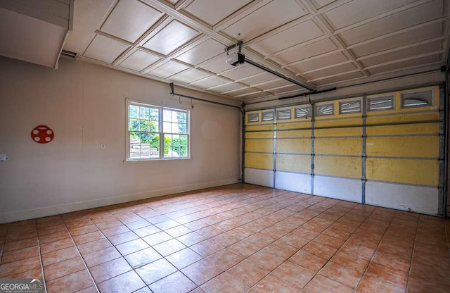 2048 Kelvin Dr, Lawrenceville, GA 30043 - garage featuring a garage door opener and baseboards