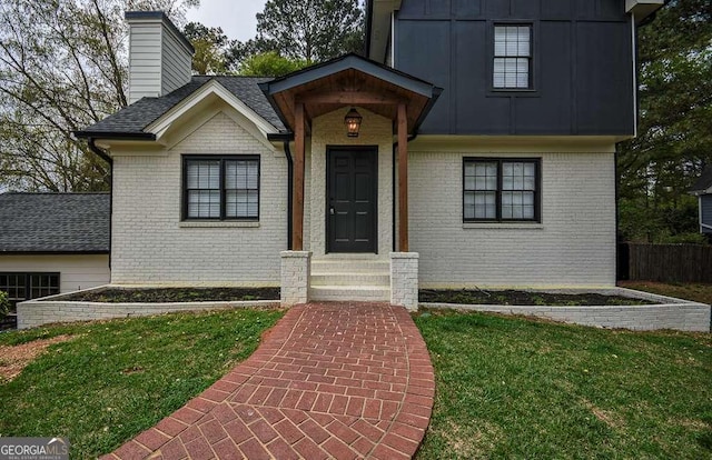 2048 Kelvin Dr, Lawrenceville, GA 30043 - doorway to property featuring brick siding and a chimney