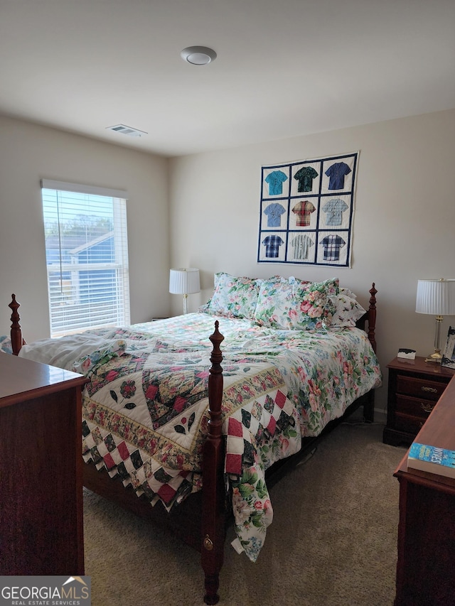 bedroom featuring carpet flooring and visible vents