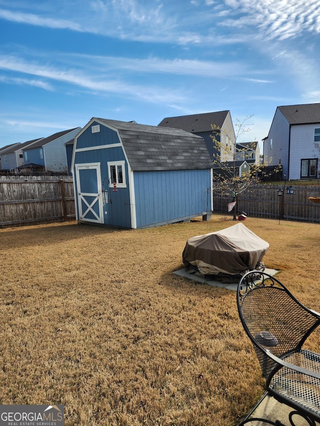 view of shed with a residential view and a fenced backyard