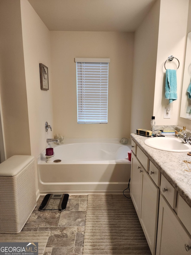full bathroom with vanity and a garden tub