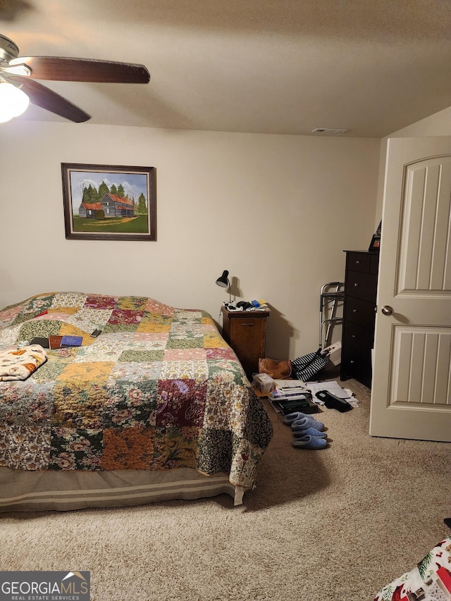 carpeted bedroom with visible vents and ceiling fan