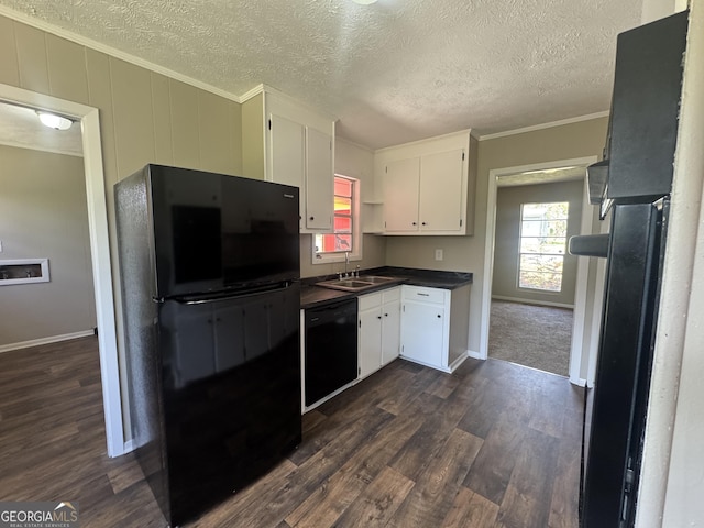 22 Spring Ave, Mcrae-Helena, GA 31055 - kitchen featuring black appliances, dark countertops, white cabinetry, crown molding, and dark wood-style flooring