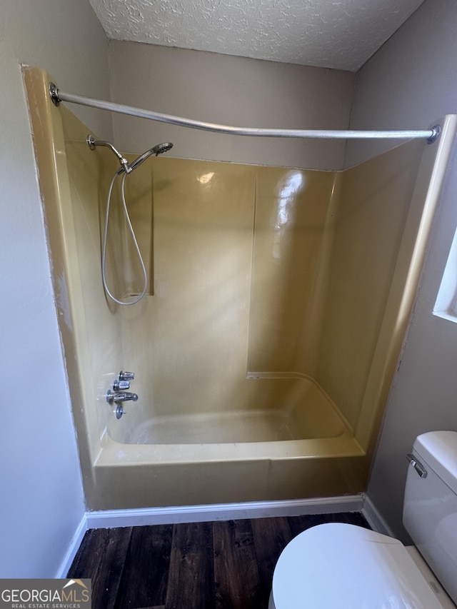 22 Spring Ave, Mcrae-Helena, GA 31055 - full bathroom with  shower combination, wood finished floors, and a textured ceiling