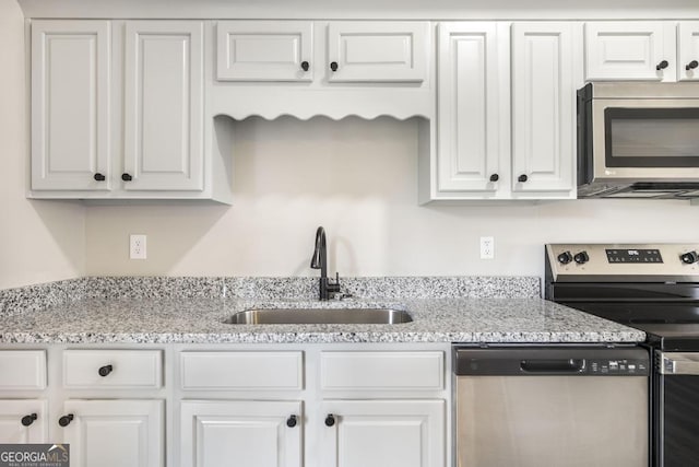 3 Joseph Rullo St, Hawkinsville, GA 31036 - kitchen with white cabinetry, a sink, light stone counters, and appliances with stainless steel finishes