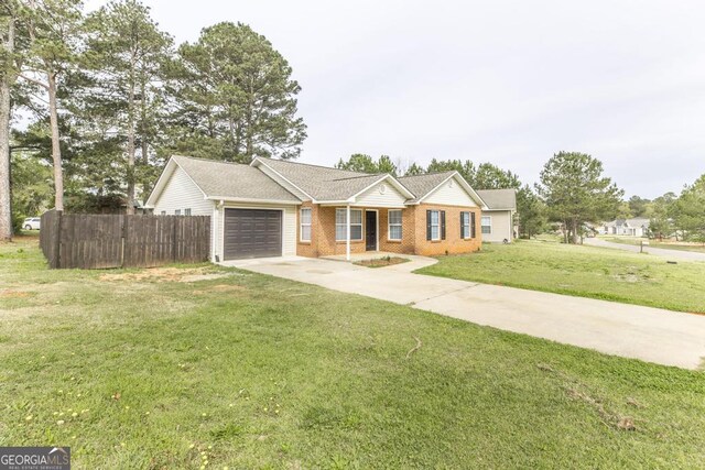 3 Joseph Rullo St, Hawkinsville, GA 31036 - single story home with fence, driveway, a front lawn, brick siding, and a garage