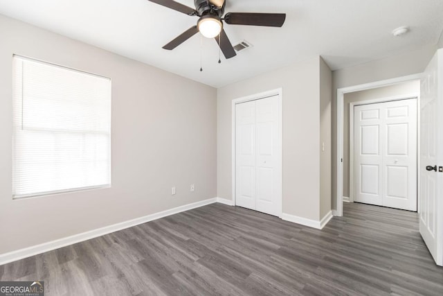 3 Joseph Rullo St, Hawkinsville, GA 31036 - unfurnished bedroom with baseboards, dark wood-style floors, ceiling fan, visible vents, and a closet