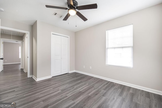 3 Joseph Rullo St, Hawkinsville, GA 31036 - unfurnished bedroom featuring a closet, attic access, dark wood finished floors, baseboards, and visible vents