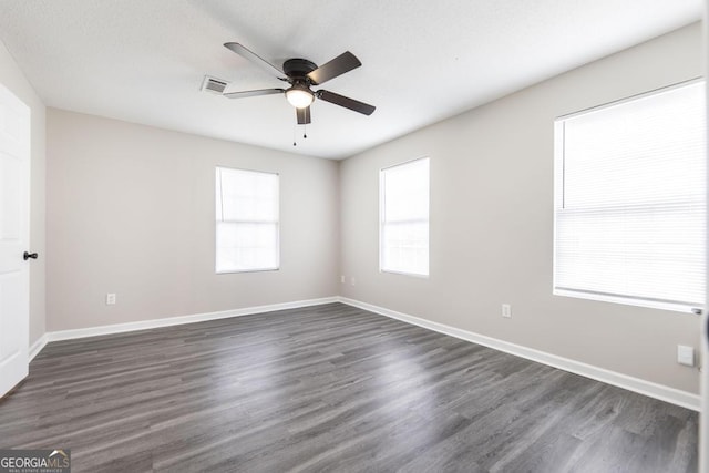 3 Joseph Rullo St, Hawkinsville, GA 31036 - spare room with dark wood-style floors, visible vents, baseboards, and a ceiling fan