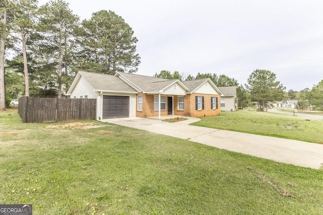 3 Joseph Rullo St, Hawkinsville, GA 31036 - ranch-style house with concrete driveway, fence, a front lawn, brick siding, and a garage