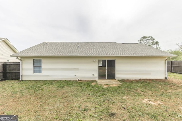 3 Joseph Rullo St, Hawkinsville, GA 31036 - rear view of property featuring roof with shingles, fence, and a yard