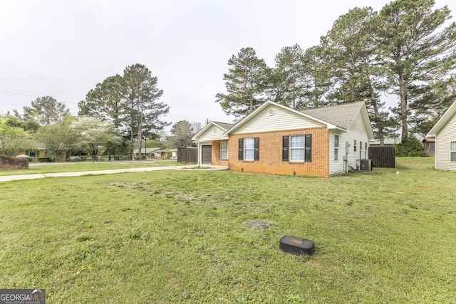 3 Joseph Rullo St, Hawkinsville, GA 31036 - view of front of home with brick siding, central AC unit, fence, and a front lawn
