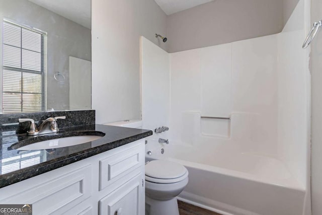 full bath with toilet, vanity, and  shower combination
