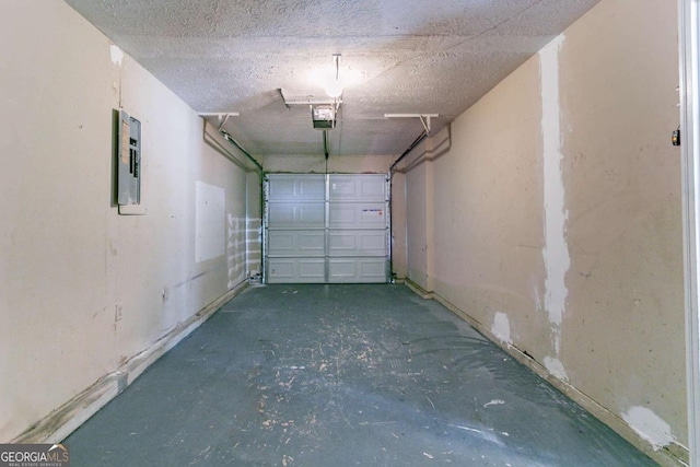 garage with electric panel and a garage door opener