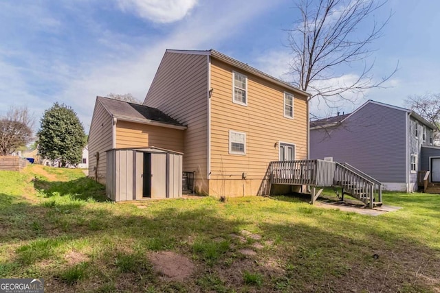 rear view of house with an outbuilding, a deck, a yard, and a storage shed