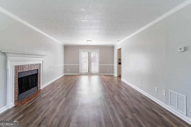 unfurnished living room featuring dark wood-style flooring, a textured ceiling, visible vents, and crown molding