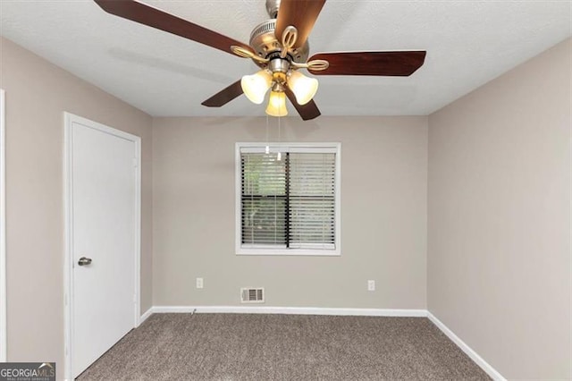 unfurnished room featuring baseboards, carpet flooring, ceiling fan, and visible vents