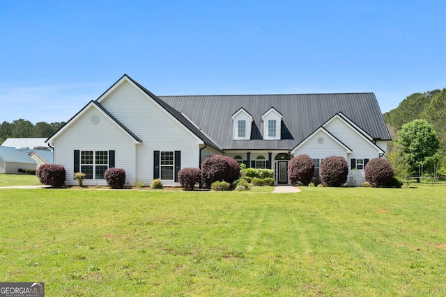 view of front of property with a front lawn and metal roof