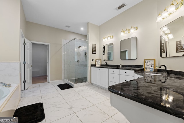 bathroom featuring visible vents, a sink, marble finish floor, a stall shower, and a garden tub