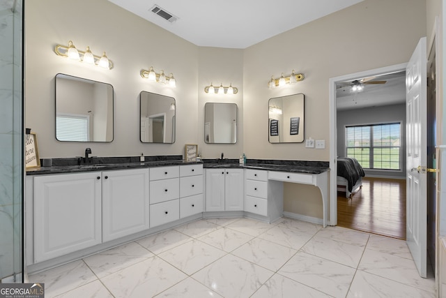 bathroom with double vanity, marble finish floor, a ceiling fan, and visible vents