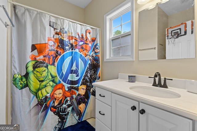 bathroom featuring vanity, a shower with curtain, and visible vents