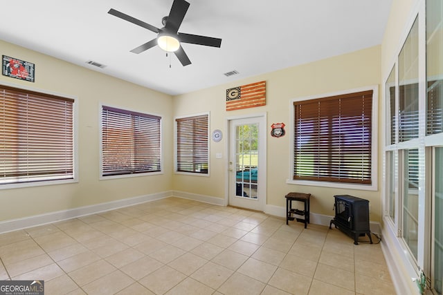 spare room featuring visible vents, baseboards, a ceiling fan, and light tile patterned flooring
