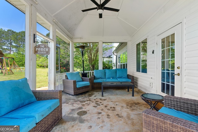 sunroom / solarium with a wealth of natural light, a ceiling fan, and an outdoor hangout area