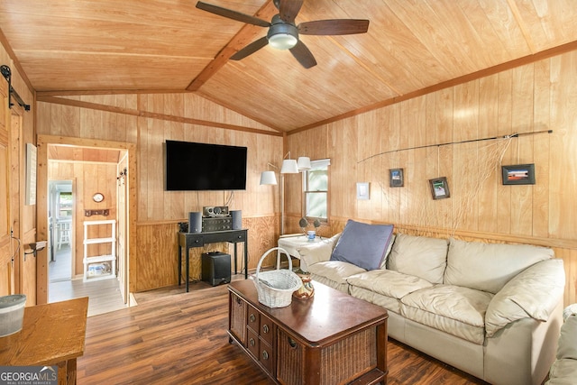 living area with ceiling fan, wood ceiling, wooden walls, wood finished floors, and vaulted ceiling