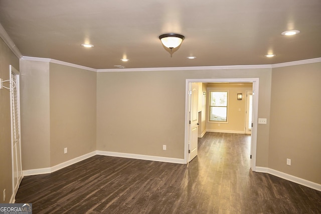 unfurnished room featuring crown molding, baseboards, and dark wood-style floors