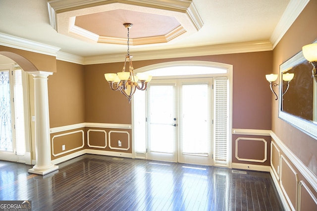 empty room with a healthy amount of sunlight, a decorative wall, and ornate columns