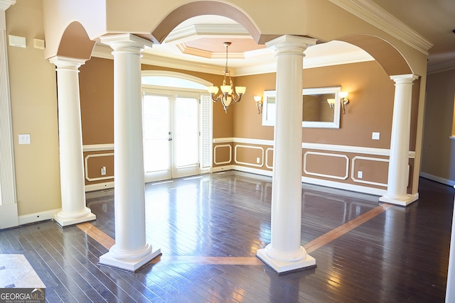 unfurnished room with crown molding, wood-type flooring, and a decorative wall